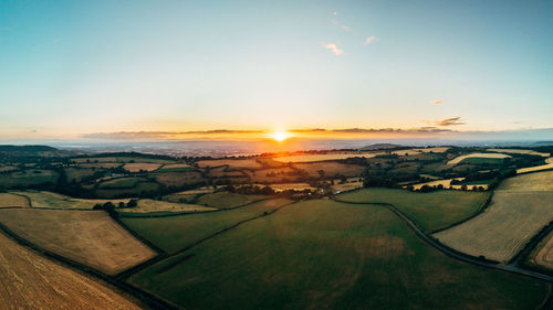 Aerial view of landscape against sky during sunset