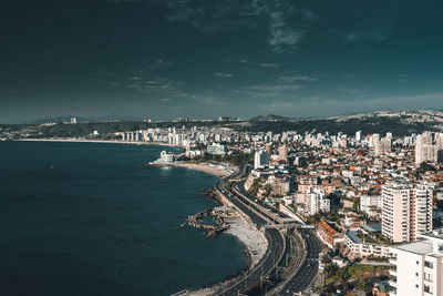 High angle view of buildings by sea against sky