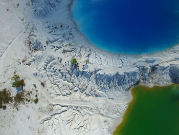 Aerial view of snowy beach by sea during winter