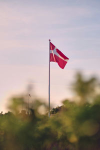 Low angle view of flag against sky