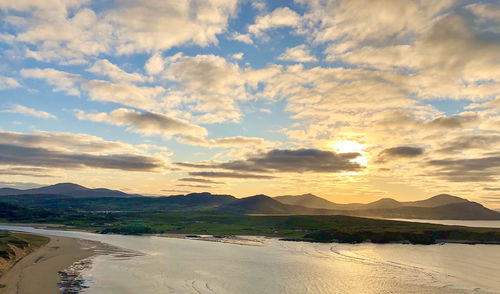 Scenic view of land against sky during sunset