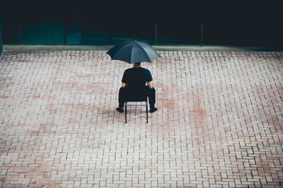 Rear view of man sitting outdoors