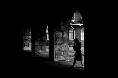 Low angle view of woman in dark room