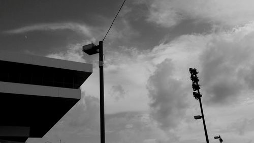 Low angle view of street light against cloudy sky