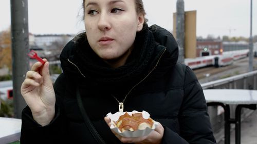 Close-up of man eating in city