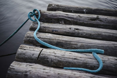 High angle view of blue rope on logs in river