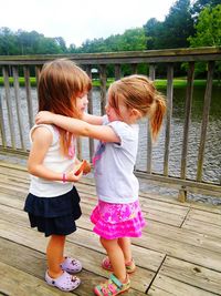 Little girl playing with arms raised