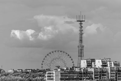 Ferris wheel in city against sky