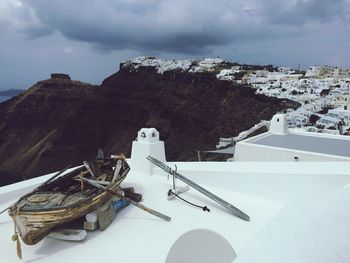 High angle view of ship on sea by mountain against sky