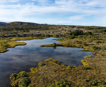 Peaceful scenery of winding river shore against gently sloping hills