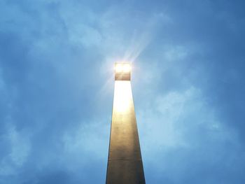 Low angle view of tower against sky on sunny day