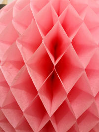 High angle view of pink umbrella on paper