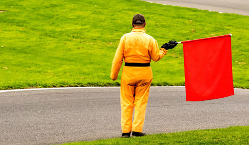 Rear view of man standing on road