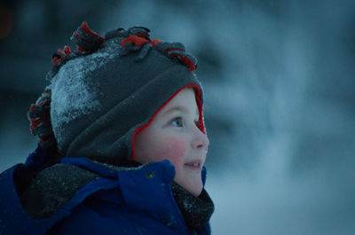 Close-up of boy looking away during winter