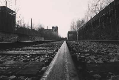 Surface level of railroad tracks against clear sky