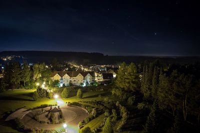 High angle view of illuminated landscape against sky at night