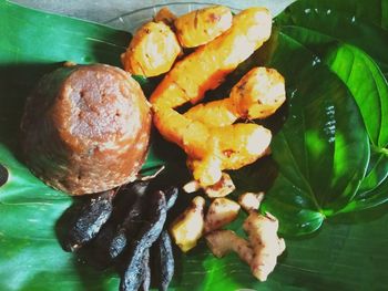 High angle view of fruits and leaves on plate