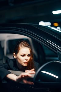 Young woman sitting in car