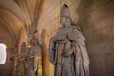 Low angle view of statue against historic building