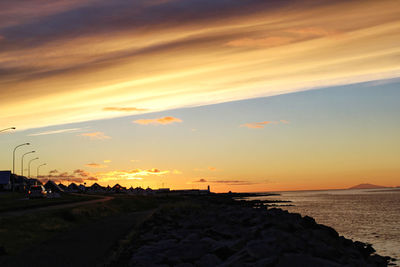 Scenic view of beach against sky during sunset