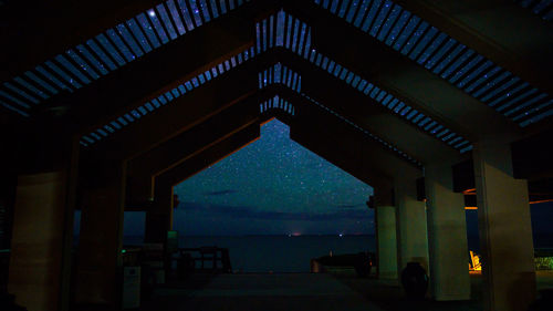 Low angle view of illuminated building against sky at night