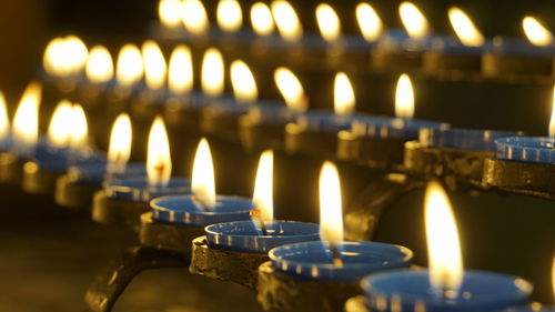 Close-up of lit candles in temple