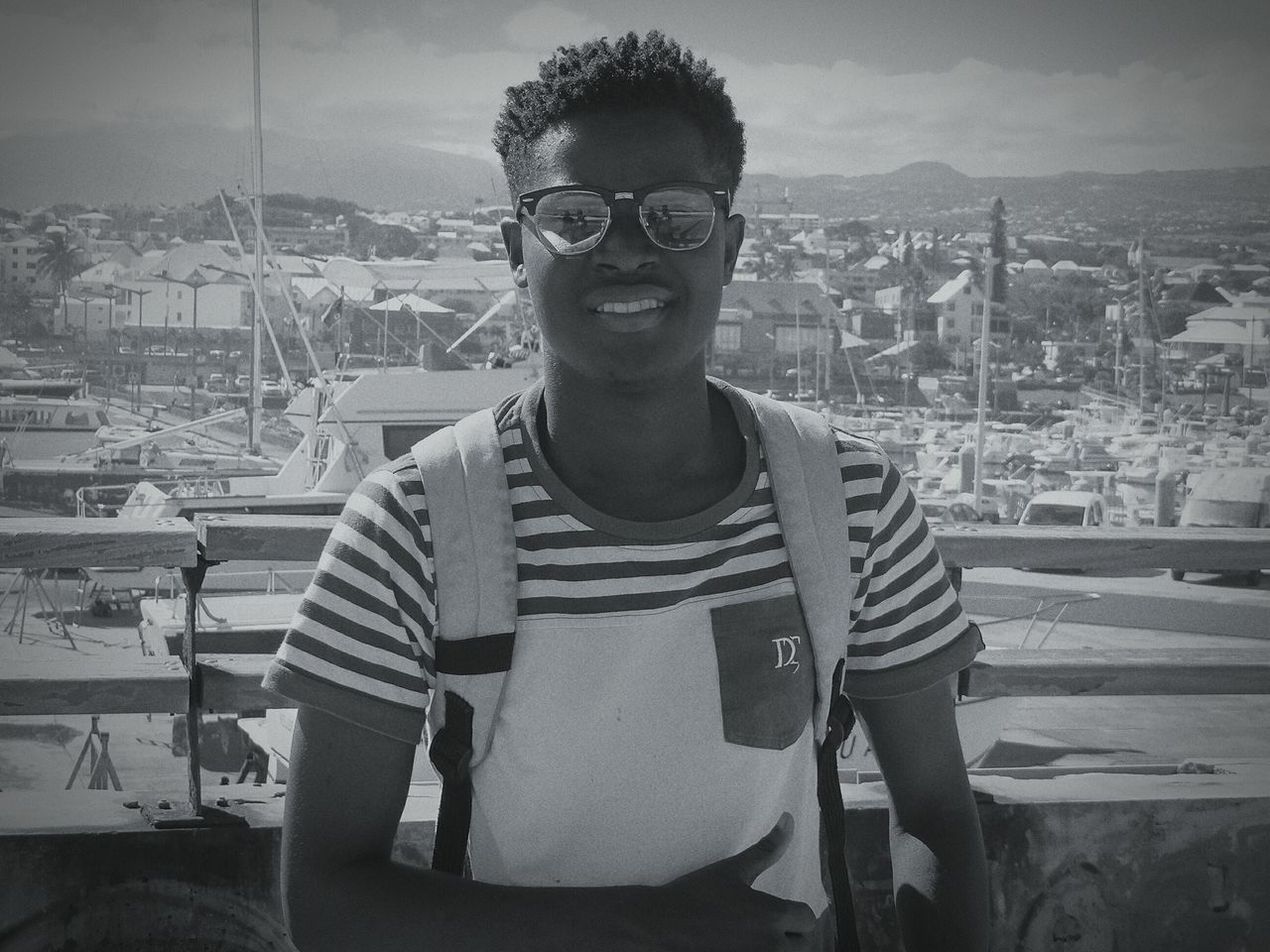 PORTRAIT OF YOUNG MAN STANDING ON WALL