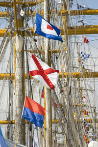 Low angle view of flags on pole against sky