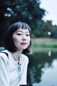 Portrait of woman against lake