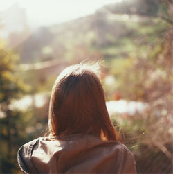 Rear view of woman with brown hair during sunny day