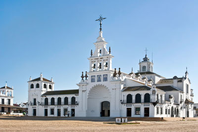 View of buildings against clear blue sky