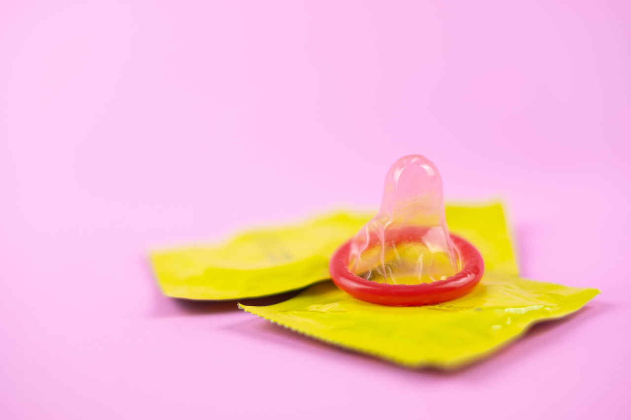 CLOSE-UP OF LEMON SLICE WITH PINK FRUIT