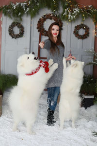 Portrait of young woman against white wall