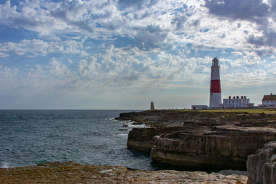 Portbilk lighthouse by sea against sky