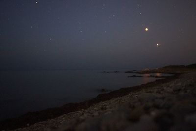 Scenic view of sea against sky at night