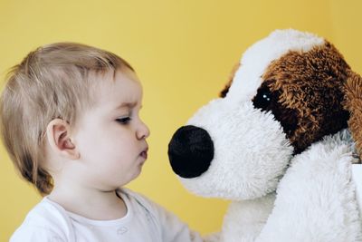 Close-up portrait of cute boy with toy