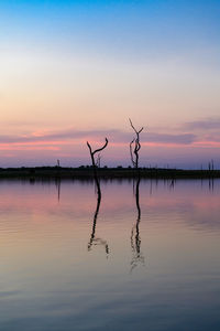 Scenic view of lake against sky during sunset