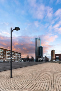 City street against sky during sunset