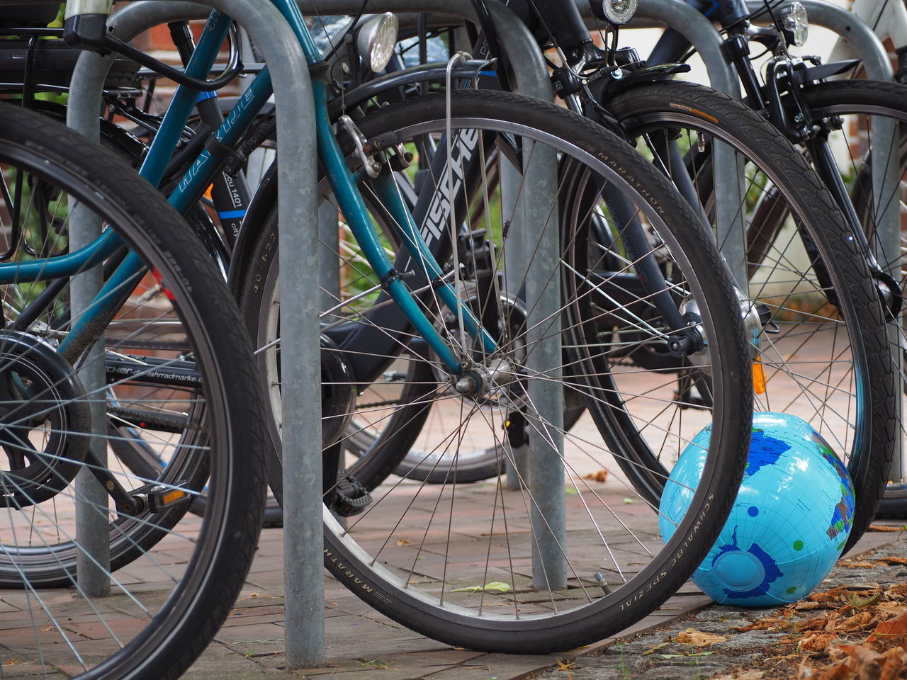 CLOSE-UP OF BICYCLE PARKED ON PARKING LOT