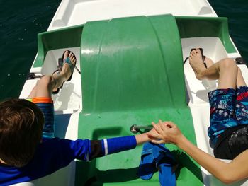 High angle view of friends boating on sea