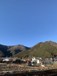 Scenic view of mountains against clear blue sky