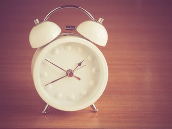 Close-up of alarm clock on table at home