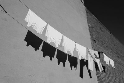 Low angle view of clothes drying against building