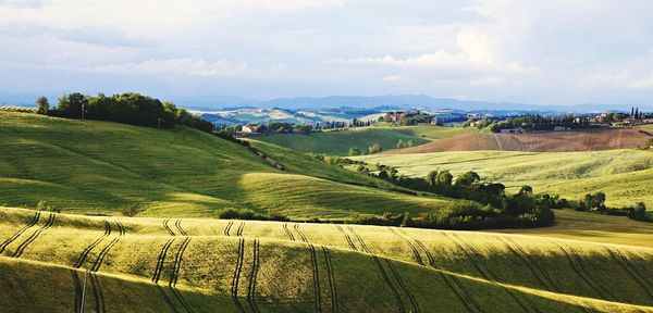 Scenic view of field against cloudy sky