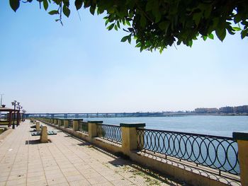 Footpath by sea against sky