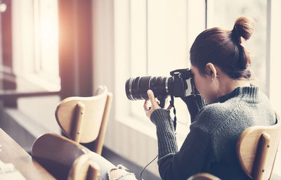 Young woman sitting on sofa at home