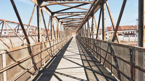 Low angle view of suspension bridge against sky