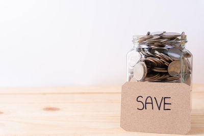 Close-up of text on glass jar on table