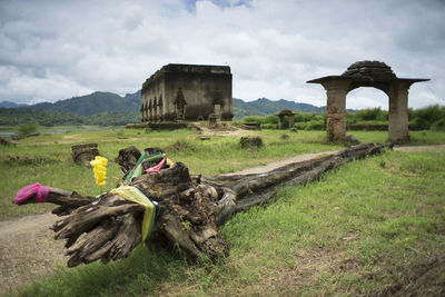 View of old ruins on field against sky