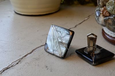 High angle view of cuff links on table